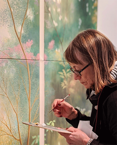 Astrid Preston adding the finishing touches to her exhibition New Paintings, December 2019