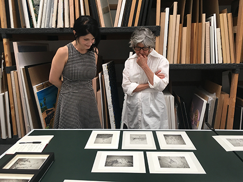 Hannah Sloan and Rose-Lynn Fisher viewing Fisher's "Tear" photographs in the back room, 2016