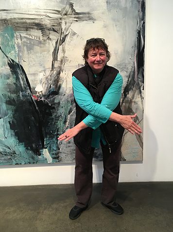 Artist Jenny Okun in front of Tom Lieber's painting Night in Day, 2016