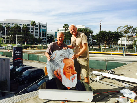 John Cerney and Craig Krull with piece of painting of Ed Moses