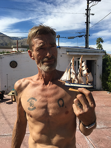 Artist Rudy De Rooy with a toy boat, outside Craig Krull Gallery's Small House Pop-Up Show in Palm Springs, 2016